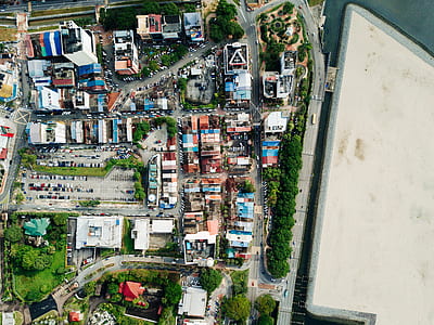 aerial photography of buildings near body of water thumbnail