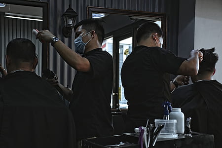 two man in black shirt doing haircut during daytime thumbnail