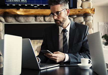 Man in Black Holding Phone thumbnail