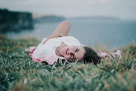woman lying on green grass thumbnail