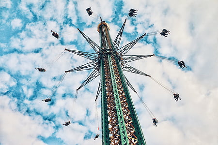 people ride on carnival under blue sky thumbnail