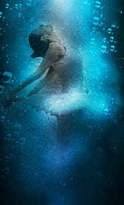 woman wearing white tutu dress with blue background thumbnail