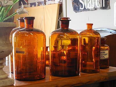 brown glass bottles on wooden table thumbnail