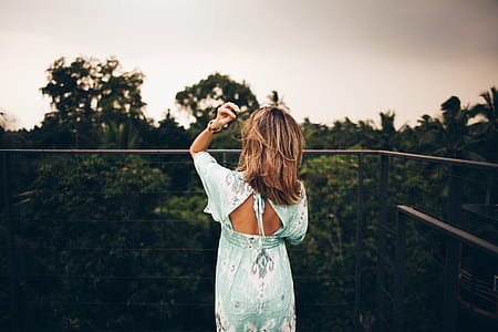 woman holding her hair during daytime thumbnail