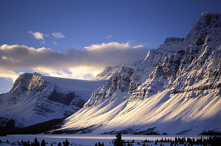 snow-covered mountains under blue sky thumbnail