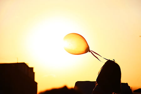 yellow balloon floating on wind during sunset thumbnail