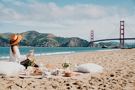 woman sitting on brown pad near golden gate bridge at daytime thumbnail