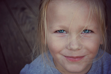 macro photography of blonde haired girl in gray shirt thumbnail
