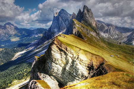 brown and green cliff under cloudy sky thumbnail