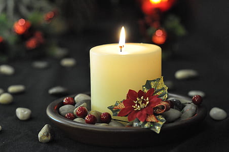 lighted white pillar candle on black tray thumbnail