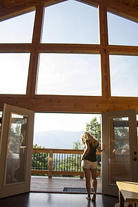 woman holding in white wooden door with full-glass panel inside house thumbnail