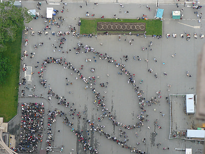 aerial photography of people fall in line near grass at daytime thumbnail
