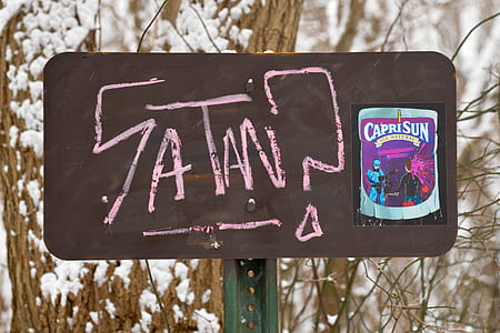 closeup photo of Satan? signage thumbnail