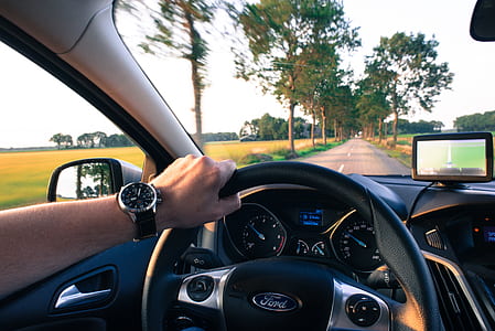 man driving Ford car thumbnail