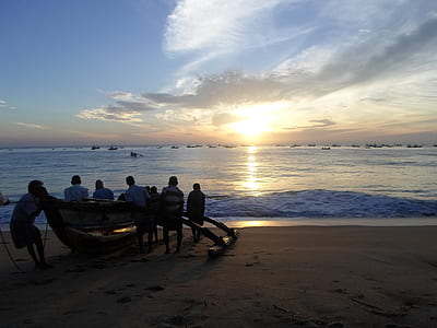 group of people near shoreline under golden hour thumbnail