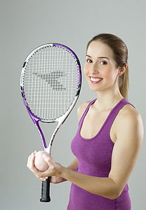 woman in purple tank top holding tennis racket and ball thumbnail