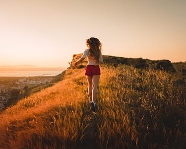 woman running across field towards rock thumbnail