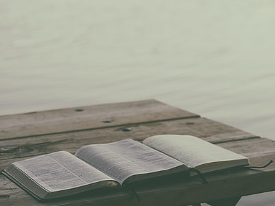 open book on top of wooden table thumbnail