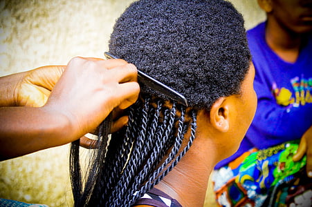 person braiding woman's hair thumbnail