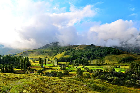landscape photography of mountain under blue sky and white sky thumbnail