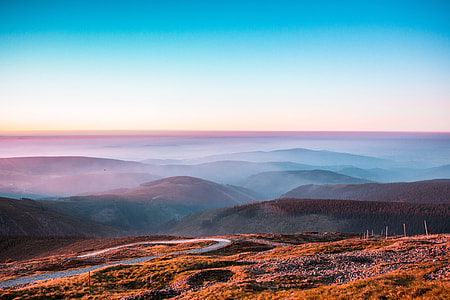 photo of brown mountains covered with fogs thumbnail