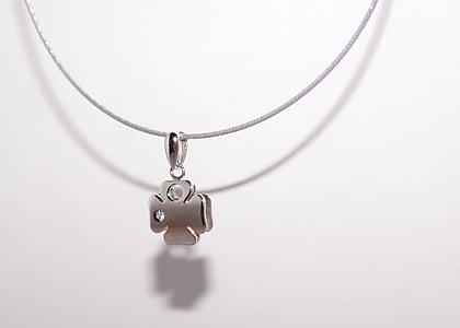 silver-colored clover pendant necklace near white wall thumbnail