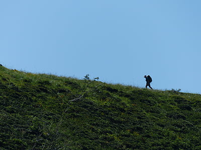 person climbing on mountain during day time thumbnail