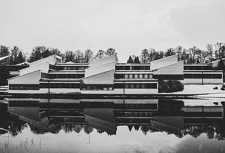 Grayscale Photo of White Painted House Near Body of the Water thumbnail