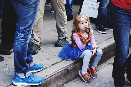 girl wearing wonder woman costume holding ice pop thumbnail