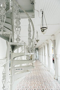 white spiral stairs on hallway during daytime thumbnail