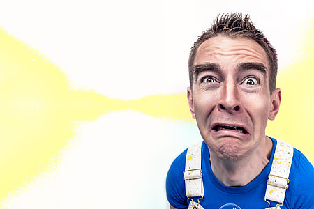 man in blue crew-neck shirt making funny face thumbnail
