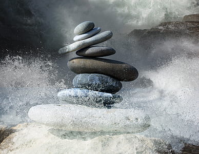 time lapse photography of water splash beside balanced stones thumbnail