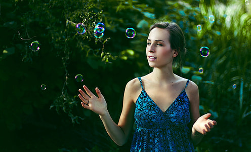 selective photography of woman in blue dress thumbnail