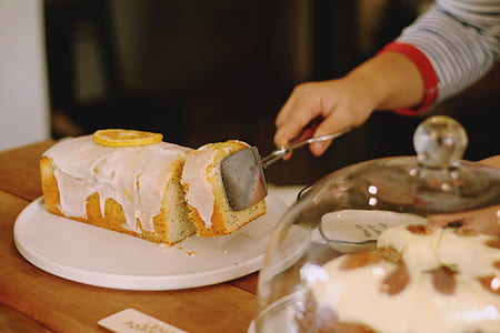 person getting bread with icing on plate thumbnail