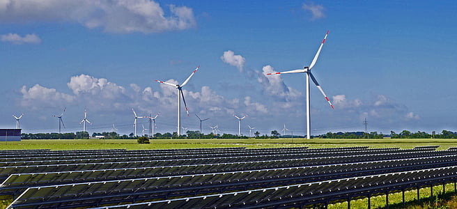 photo of wind turbine on field near solar panel thumbnail