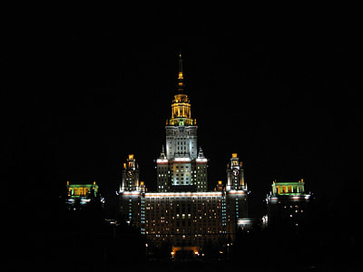 gray and yellow lighted building at nighttime thumbnail