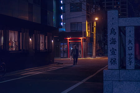 man walking on road near building thumbnail