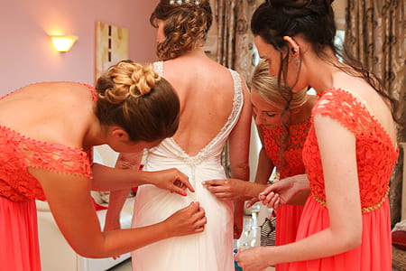 three woman fixing wedding gown thumbnail