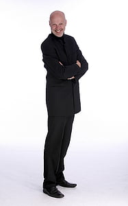 smiling man wearing black suit jacket thumbnail