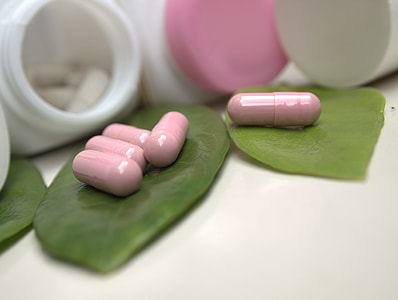 close-up photography of pink pill on green leaf thumbnail