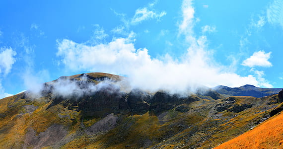 brown rocky mountains under white clouds thumbnail