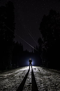 man wearing black hoodie under starry sky thumbnail