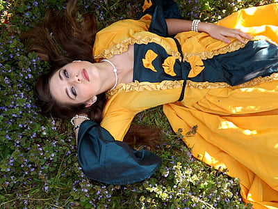 woman wearing orange dress lying on flowers thumbnail