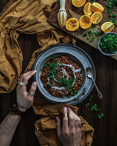 cook food on tray with spoon in front of sliced of lemons thumbnail