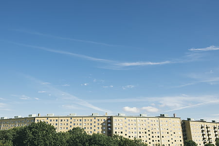 landscape photography of beige building beside trees thumbnail