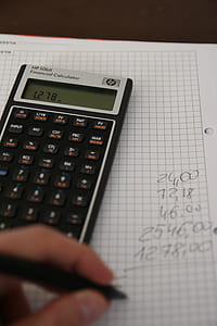 black financial calculator on top of graphing paper thumbnail
