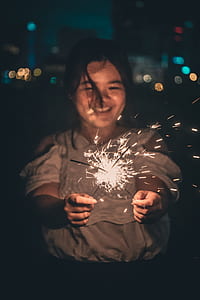 woman holding sparkler during daytime thumbnail