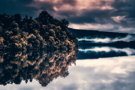 reflex photography of island and nimbus clouds thumbnail