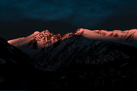 snow covered mountain during night time thumbnail
