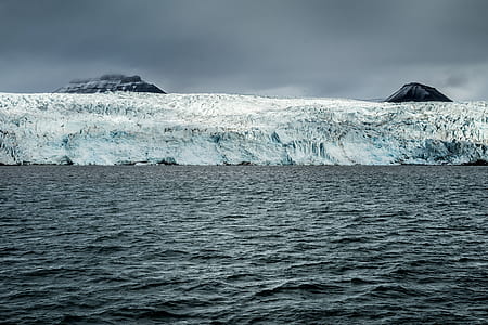 body of water near glacier mountains thumbnail
